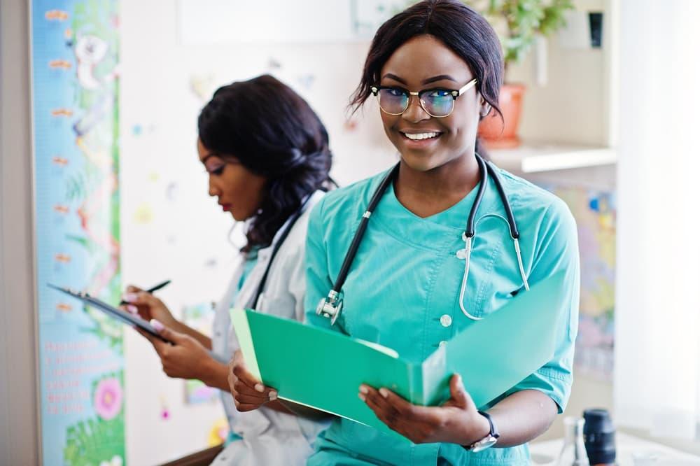 Two medical professionals reviewing notes