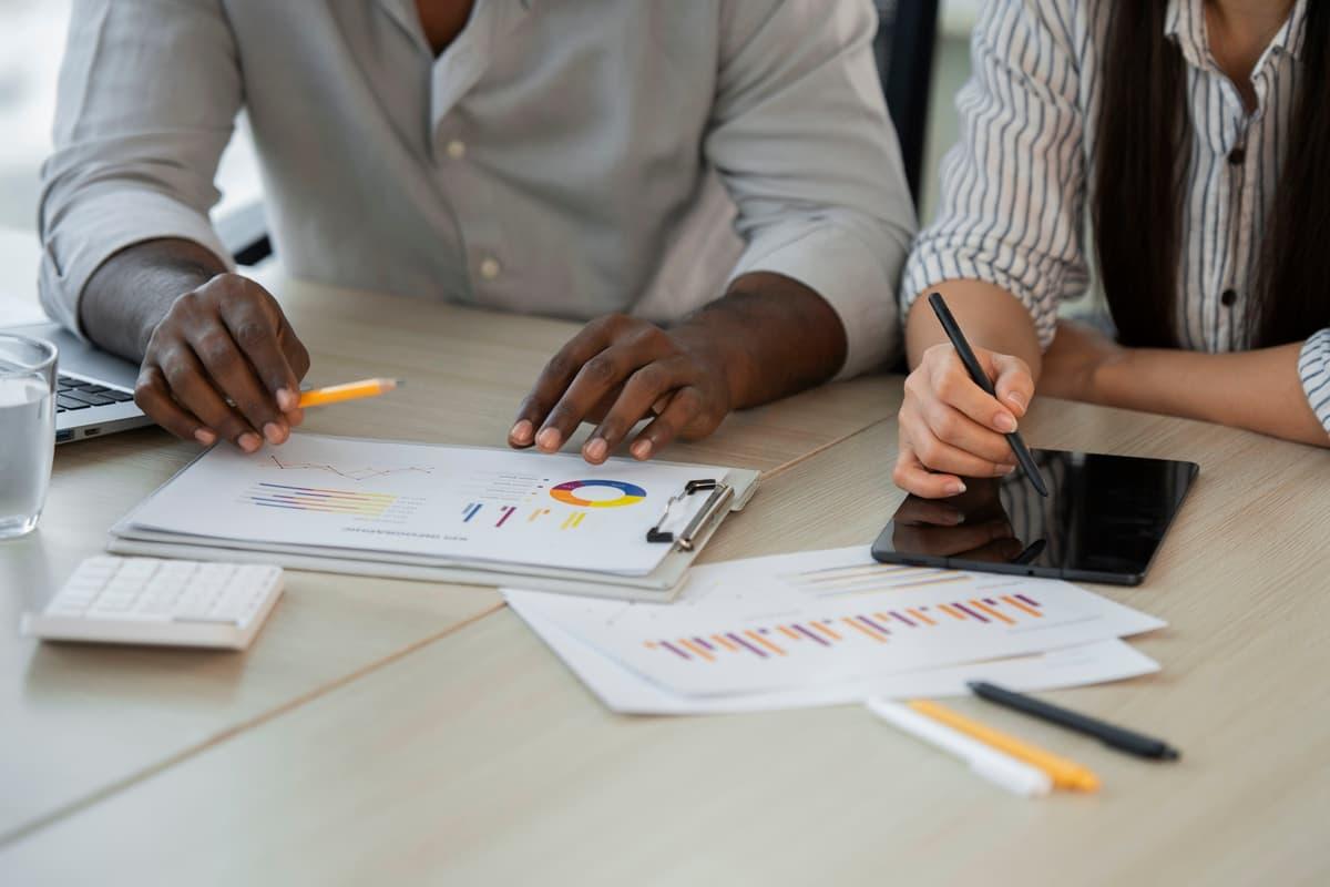 Advisers reviewing financial documents at a desk