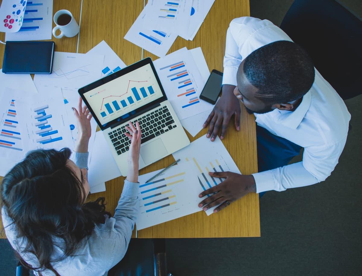 Analyst working through charts and reports on a laptop